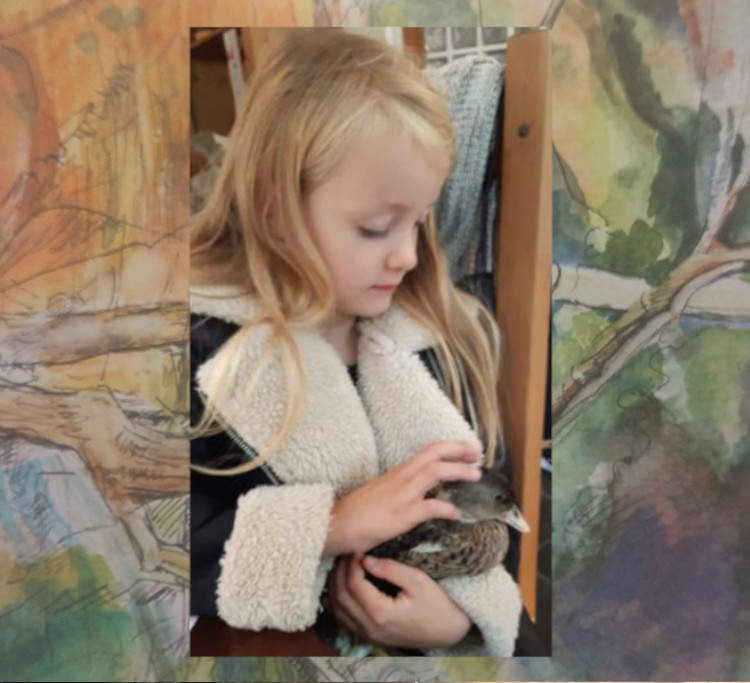 Young girl holding a duckling